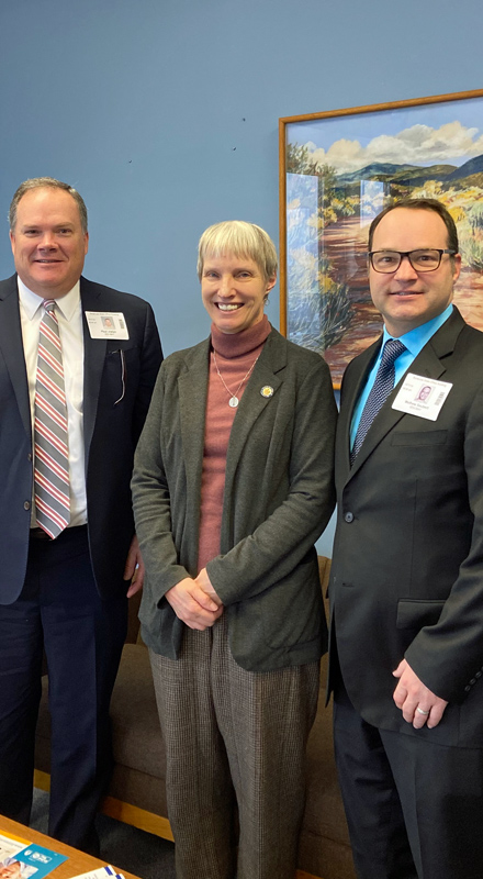 AccessCNY Executive Director Paul Joslyn and Associate Executive Director Matt Seubert pose with State Senator Rachel May