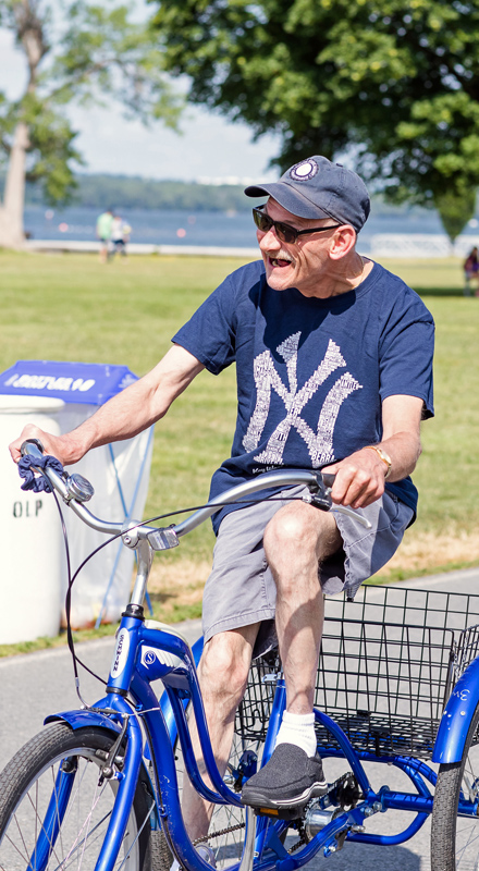 An AccessCNY participant rides a tricycle at Onondaga Lake Park.